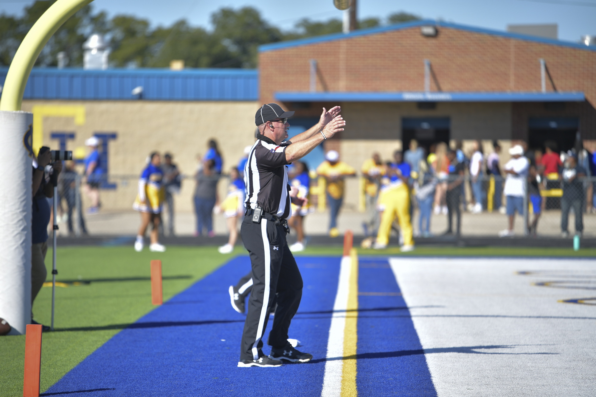 Football official signaling from the end zone during a game