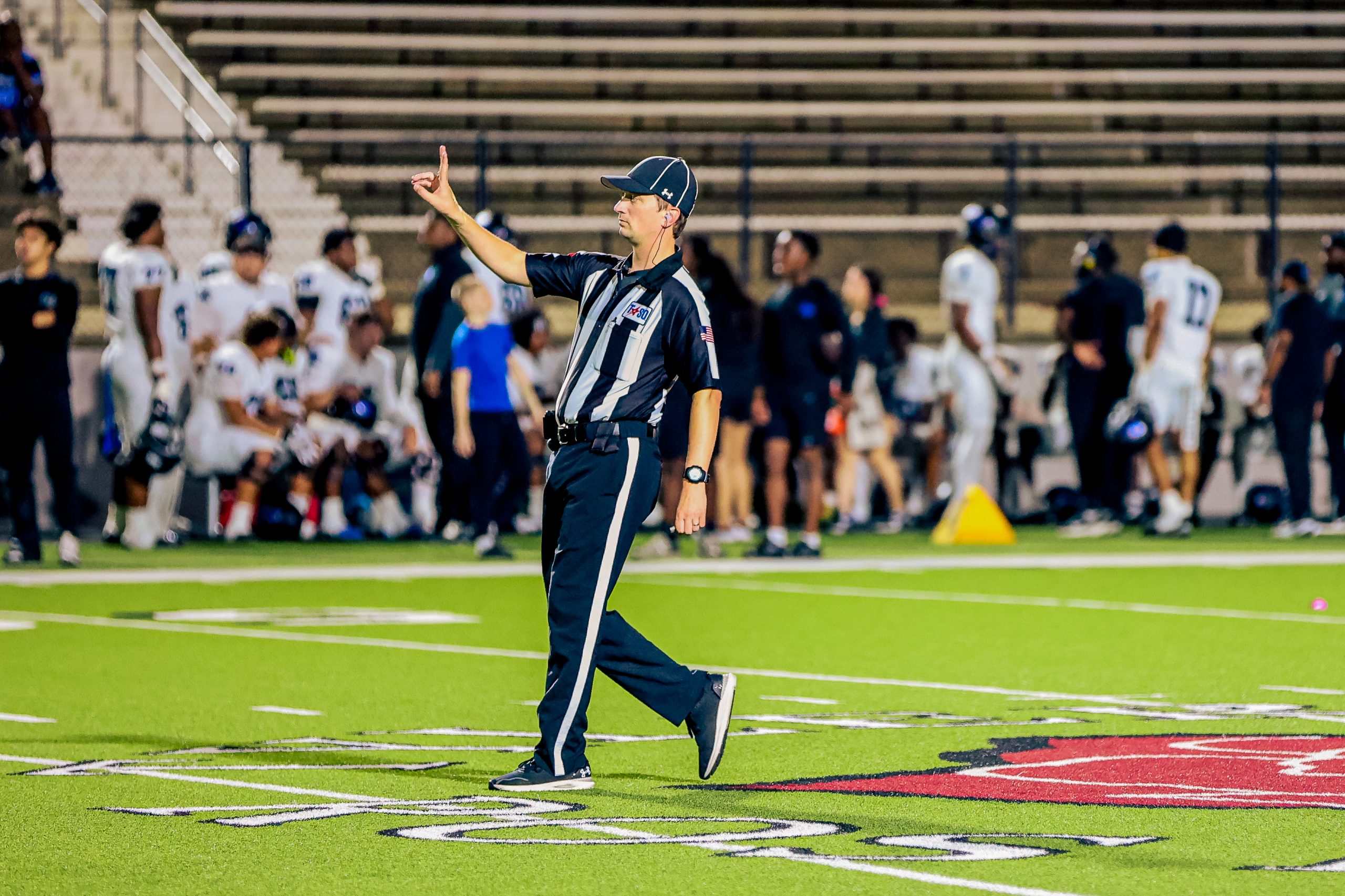 Football official signaling during a game